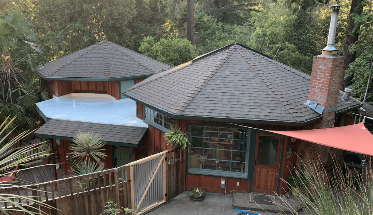 Shingle and flat roof wooded home