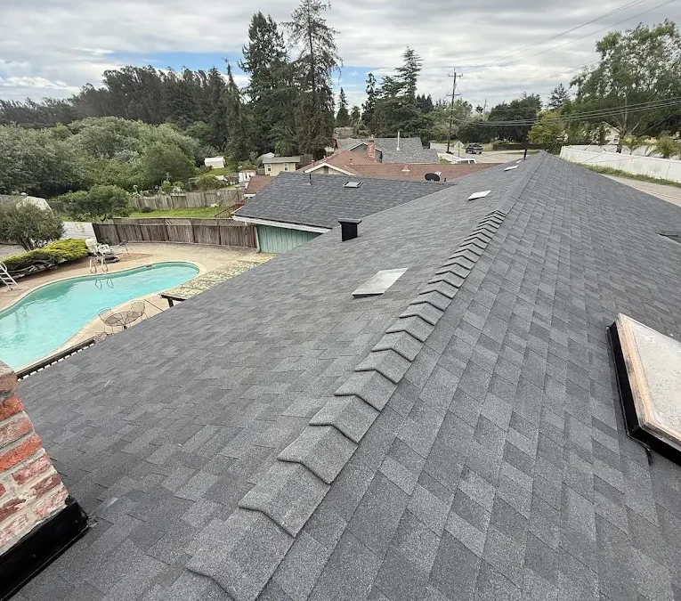 Roof inspection view of a gray asphalt shingle roof on a Capitola, CA home