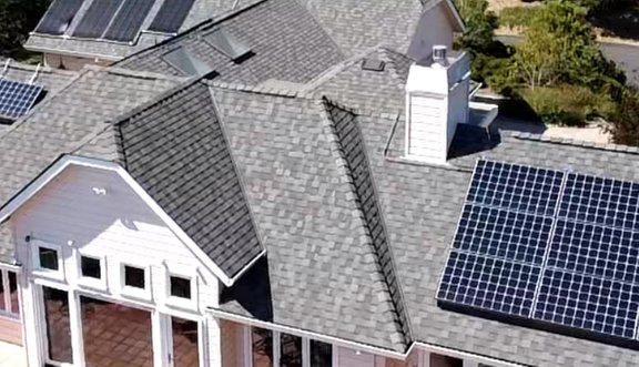 Close-up of solar panels mounted on a newly replaced asphalt shingle roof in Capitola, CA